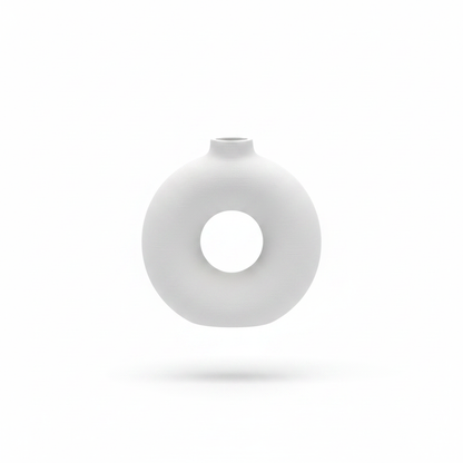 Single white donut circle vase on white background, no plants