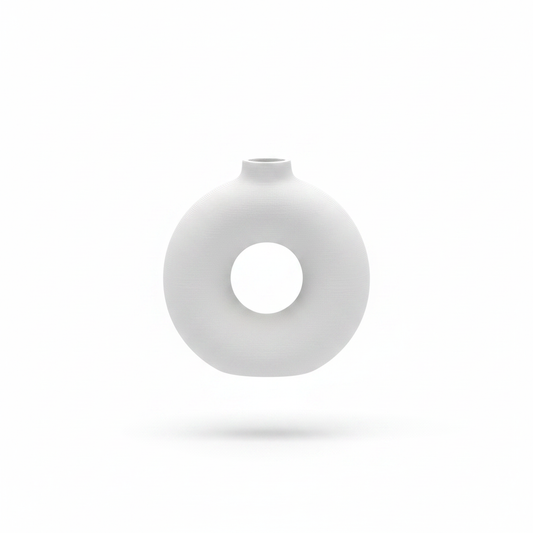 Single white donut circle vase on white background, no plants