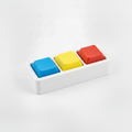 3D printed fidget macro pad with white base and blue, yellow, red keycap buttons on gray background