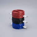 Three stacked 3D printed geometric cable organizer boxes in red, black, and navy blue with charging cables