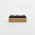 3D printed fidget macro pad with tan base and black keycap buttons on gray background