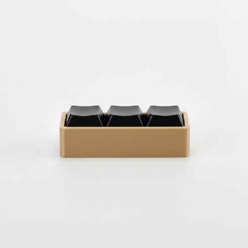 3D printed fidget macro pad with tan base and black keycap buttons on gray background