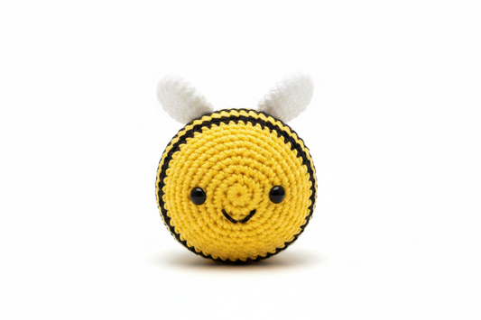 Crocheted bee stuffed animal on white background