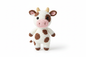 Crocheted cow stuffed animal on white background