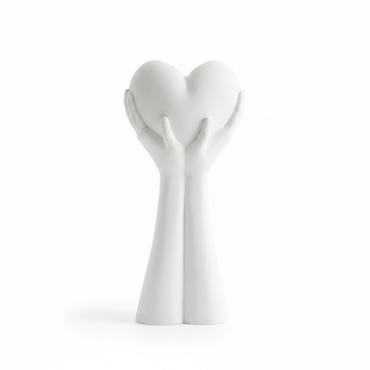 White 3D printed hands holding a heart sculpture on white background
